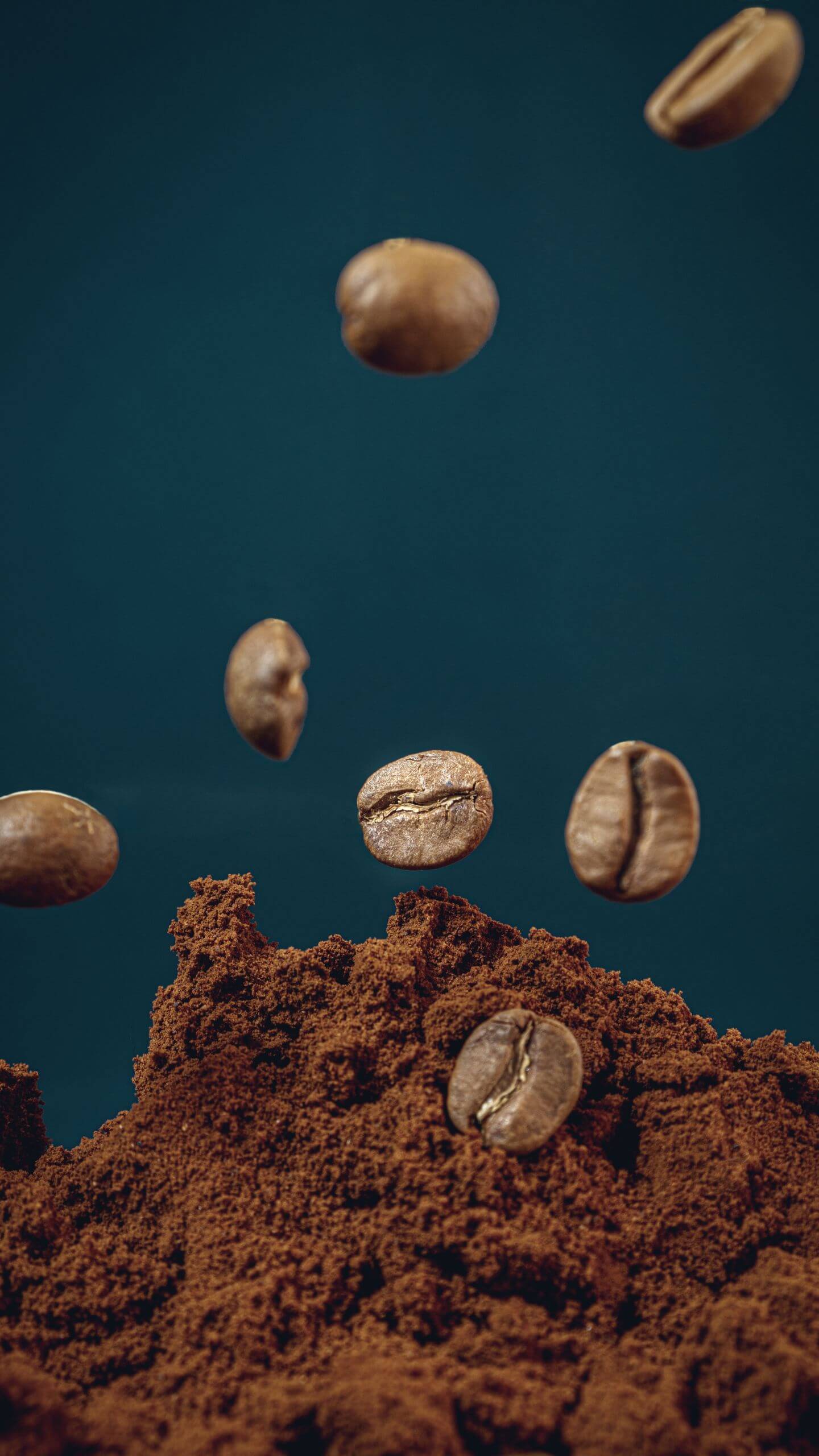Falling Coffee Beans Against a Blue Background